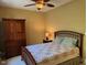 Cozy bedroom with comfortable bed, wooden armoire, and soft lighting for a relaxing atmosphere at 2012 Silverleaf Dr, Youngsville, NC 27596