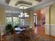 Dining room boasts hardwood floors, elegant lighting, and views into the foyer at 2012 Silverleaf Dr, Youngsville, NC 27596