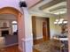 Dining room boasts hardwood floors, elegant lighting, and views into the living room at 2012 Silverleaf Dr, Youngsville, NC 27596