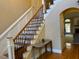Elegant foyer with a staircase, hardwood floors, and decorative table, creating a welcoming entrance at 2012 Silverleaf Dr, Youngsville, NC 27596