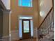 Elegant foyer with decorative door and stairs with iron spindles at 2012 Silverleaf Dr, Youngsville, NC 27596