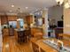 A fully equipped kitchen featuring wood cabinets, stainless steel appliances, and an island with bar seating at 2012 Silverleaf Dr, Youngsville, NC 27596