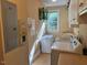 Functional laundry room with modern appliances, storage cabinets, and a utility sink for convenience at 2012 Silverleaf Dr, Youngsville, NC 27596