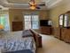 Spacious main bedroom with large windows, tray ceiling, and wooden furniture at 2012 Silverleaf Dr, Youngsville, NC 27596