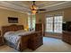 Inviting main bedroom with tray ceiling, windows, and wood furniture at 2012 Silverleaf Dr, Youngsville, NC 27596