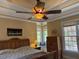 Relaxing main bedroom featuring a ceiling fan, windows, and a wooden dresser at 2012 Silverleaf Dr, Youngsville, NC 27596