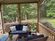 Cozy screened porch featuring wicker furniture, views of the lush backyard, and a relaxing atmosphere at 2012 Silverleaf Dr, Youngsville, NC 27596
