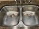 The stainless-steel double sink features a granite countertop and modern fixtures at 2012 Silverleaf Dr, Youngsville, NC 27596