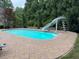 Beautiful swimming pool with stone patio and a fun slide at 2012 Silverleaf Dr, Youngsville, NC 27596