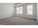 Bedroom with plush carpeting and large windows providing natural light at 255 Chesapeake Commons St # 90, Garner, NC 27529