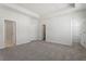 Spacious bedroom with gray carpet and multiple closets and doorways at 255 Chesapeake Commons St # 90, Garner, NC 27529