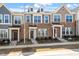 Charming townhomes showcase brick and siding exteriors, complemented by manicured landscaping and inviting entryways at 255 Chesapeake Commons St # 90, Garner, NC 27529
