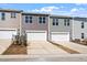 Modern townhome exteriors featuring individual garages, contemporary color schemes, and well-manicured lawns at 255 Chesapeake Commons St # 90, Garner, NC 27529