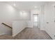 Upstairs hallway with carpet, natural wood railing, and ample lighting at 255 Chesapeake Commons St # 90, Garner, NC 27529