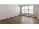 Open living area showcasing hardwood floors, neutral walls, and large window at 255 Chesapeake Commons St # 90, Garner, NC 27529