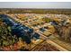 Aerial view showcasing a large neighborhood with trees, homes, and beautiful surroundings at 316 Robert Howe Dr, Fuquay Varina, NC 27526