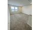 Expansive bonus room with neutral carpet, recessed lighting, and double windows providing natural light at 316 Robert Howe Dr, Fuquay Varina, NC 27526