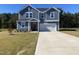 Two story home boasts a well-manicured lawn, an inviting entrance, and attached garage at 316 Robert Howe Dr, Fuquay Varina, NC 27526