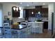 Modern kitchen featuring stainless steel appliances, dark cabinets, and an island with white countertops at 316 Robert Howe Dr, Fuquay Varina, NC 27526