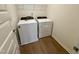 Laundry room with new, white, front-loading washer and dryer next to each other at 316 Robert Howe Dr, Fuquay Varina, NC 27526