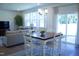Bright living room with large windows, a comfortable sofa, and a view of the backyard at 316 Robert Howe Dr, Fuquay Varina, NC 27526
