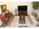A cozy living room with a tan sofa, wooden furniture, patterned chairs, and a stylish rug in a well-lit space at 316 Robert Howe Dr, Fuquay Varina, NC 27526