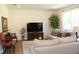 This is an inviting living room with an area rug, sofa, wooden furniture, and chairs in a new construction home at 316 Robert Howe Dr, Fuquay Varina, NC 27526
