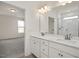 Double vanity bathroom with walk-in shower and access to bedroom at 432 Old Fashioned Way, Lillington, NC 27546