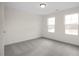 Well-lit bedroom featuring two large windows and grey carpet at 432 Old Fashioned Way, Lillington, NC 27546