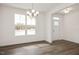 Bright dining room features hardwood floors, chandelier, and large windows at 432 Old Fashioned Way, Lillington, NC 27546