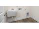 Simple laundry room with utility sink and vinyl flooring at 432 Old Fashioned Way, Lillington, NC 27546