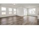 Open living room with hardwood floors and access to a back deck at 432 Old Fashioned Way, Lillington, NC 27546