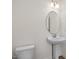 Small powder room with pedestal sink and oval mirror at 432 Old Fashioned Way, Lillington, NC 27546