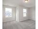 Spacious bedroom with two large windows and grey carpet at 65 Wild Turkey Way Way, Lillington, NC 27546