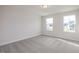 Bright bedroom with two windows and grey carpet at 65 Wild Turkey Way Way, Lillington, NC 27546
