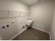 Bright laundry room with utility sink and shelving at 65 Wild Turkey Way Way, Lillington, NC 27546