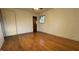 Hardwood floor bedroom with ceiling fan and window at 720 Darby St, Raleigh, NC 27610