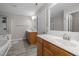 Bright bathroom featuring double sinks, vanities, mirrors and great lighting at 722 Redford Place Dr, Rolesville, NC 27571