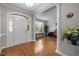 Welcoming home foyer with hardwood floors, decorative columns, and an arched doorway at 722 Redford Place Dr, Rolesville, NC 27571