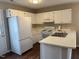 Galley kitchen with white cabinets and appliances at 747 Brewers Glynn Ct, Wake Forest, NC 27587