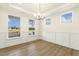 Bright dining room with wainscoting, wood floors, and ample natural light at 87 Browning Mill Dr, Wendell, NC 27591