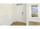 Bright entryway featuring hardwood floors, wainscoting, and a white front door at 87 Browning Mill Dr, Wendell, NC 27591
