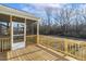 A screened porch features wooden decking, railing, and a screen door with views of the backyard at 87 Browning Mill Dr, Wendell, NC 27591