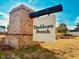 Buckhorn Branch community sign with brick base against a blue sky in a neighborhood at 87 Nimble Way # 187, Clayton, NC 27520