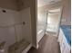 Bright bathroom with a shower and bathtub combination, tile floor and a white vanity at 17 Maxwell Farm Ln, Selma, NC 27576