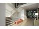 Bright foyer featuring glass-railed staircase, hardwood floors, and stylish accent bench at 216 Dartmouth Rd, Raleigh, NC 27609