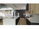 Open kitchen featuring a large island with seating, modern appliances, and custom cabinetry at 216 Dartmouth Rd, Raleigh, NC 27609