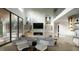 Open living room with fireplace, modern furnishings, and large windows offering abundant natural light at 216 Dartmouth Rd, Raleigh, NC 27609