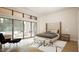 Bright primary bedroom with large windows, a sitting area, and neutral decor for a relaxing retreat at 216 Dartmouth Rd, Raleigh, NC 27609