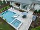 Aerial view of backyard with a pool, hot tub, patio and outdoor seating, ideal for relaxation at 216 Dartmouth Rd, Raleigh, NC 27609